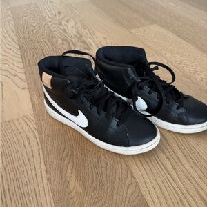 Nike women’s Black and White High-Top Sneakers